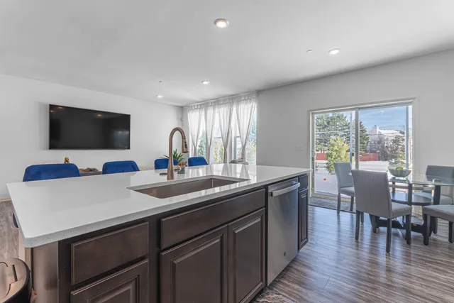 a kitchen with stainless steel appliances granite countertop a stove a sink and a microwave