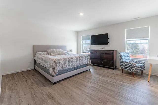 a bedroom with a bed and cabinets