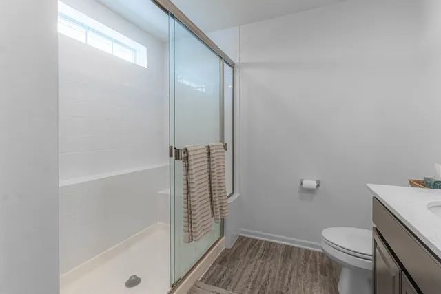 a bedroom with a bed next to a window