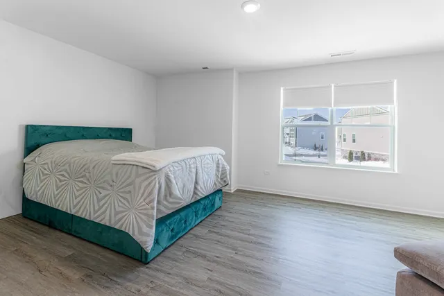 a bedroom with a bed and a table