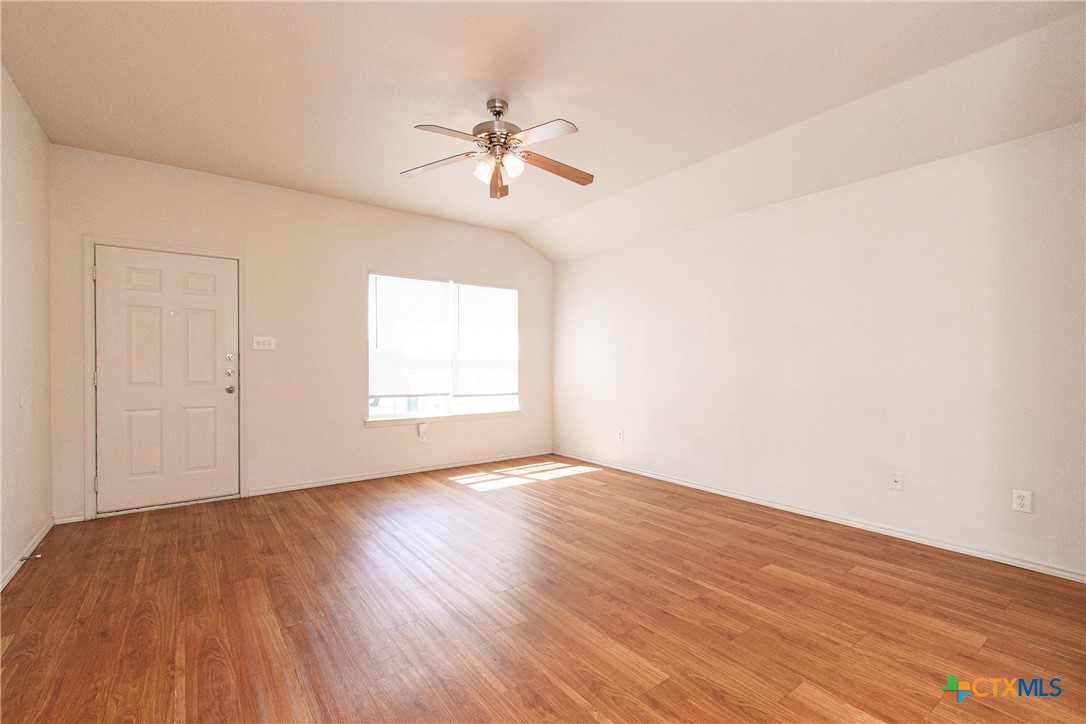 6509 Temora Loop, Unit A Killeen, TX 76549 - Photo 4 of 19 a view of an empty room with wooden floor and a window