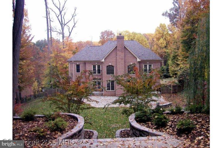a view of a house with a yard and garden