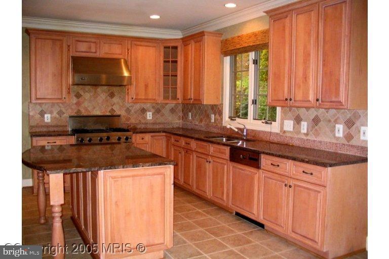 624 Live Oak Drive McLean, VA 22101 - Photo 6 of 10 a kitchen with stainless steel appliances granite countertop a sink a stove and a microwave