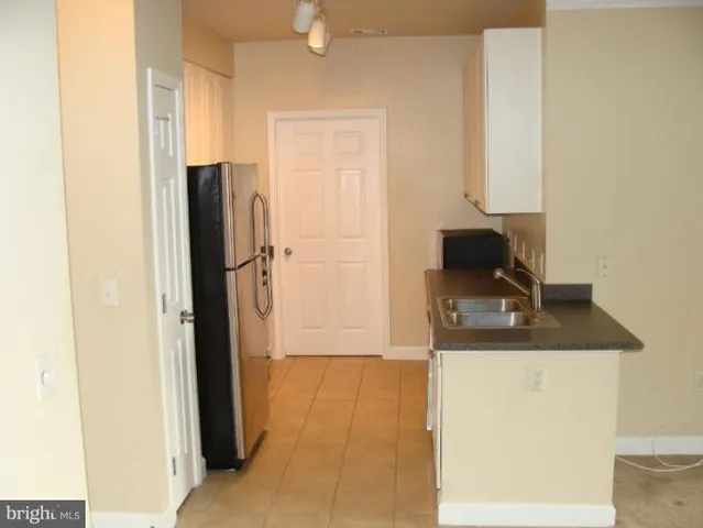 a kitchen with a refrigerator and a sink