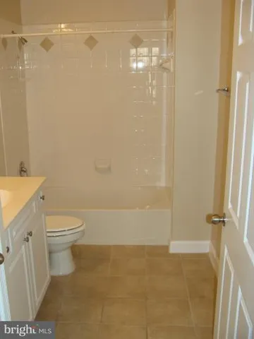 a bathroom with a toilet a sink and shower
