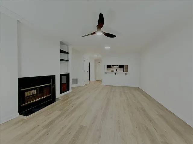 a view of empty room with a fireplace and cabinet