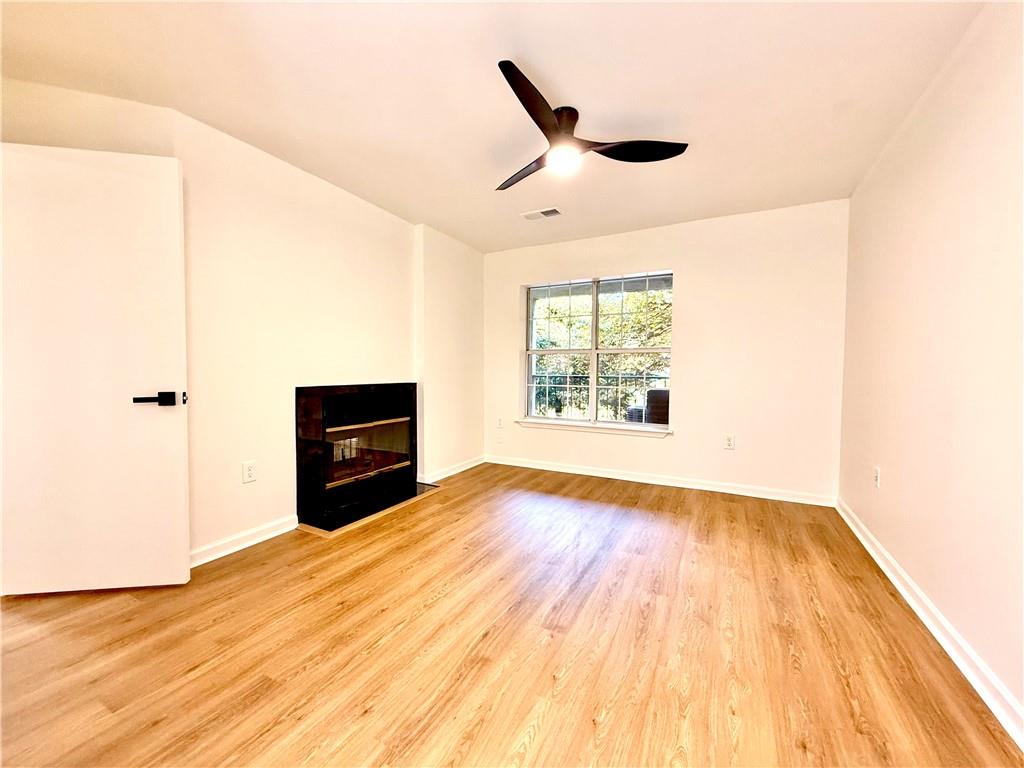 3655 Habersham Road Northeast, Unit A212 Atlanta, GA 30305 - Photo 15 of 21 a view of empty room with wooden floor and fan