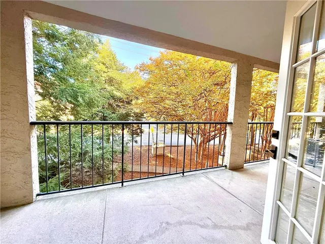 a view of a white building with a outdoor space