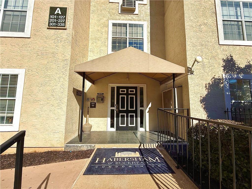 3655 Habersham Road Northeast, Unit A212 Atlanta, GA 30305 - Photo 19 of 21 a view of a brick house with large windows