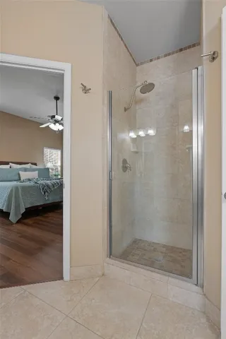 a bathroom with a glass shower door