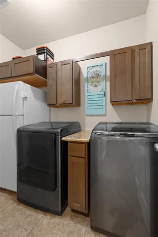 a kitchen with granite countertop white cabinets and stainless steel appliances