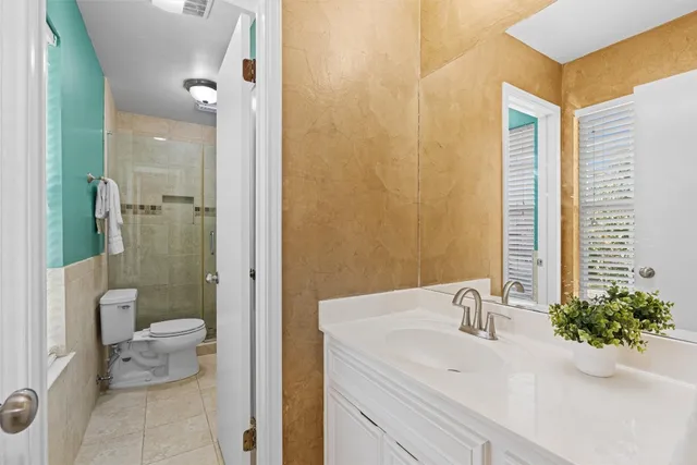 a bathroom with a sink and mirror with toilet