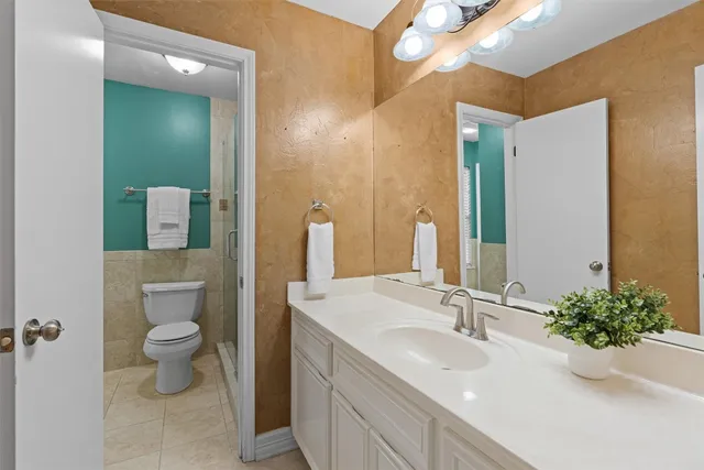 a bathroom with a sink a toilet and mirror