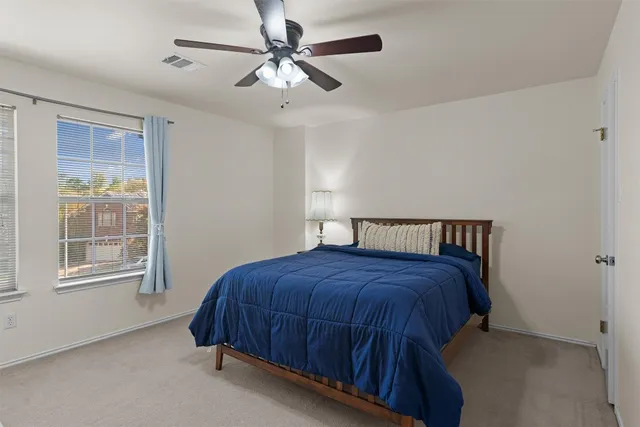 a bedroom with a bed and window