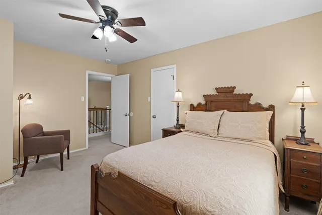 a bedroom with a bed and a chair