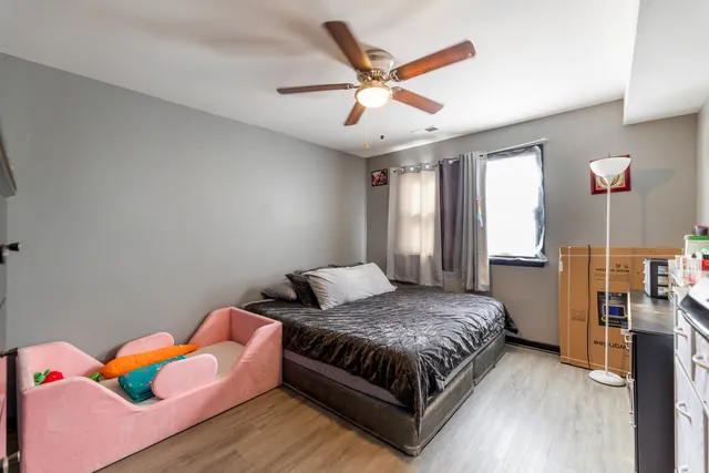 a bedroom with a bed and a chandelier