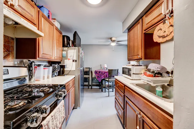 a kitchen with stove and cabinets