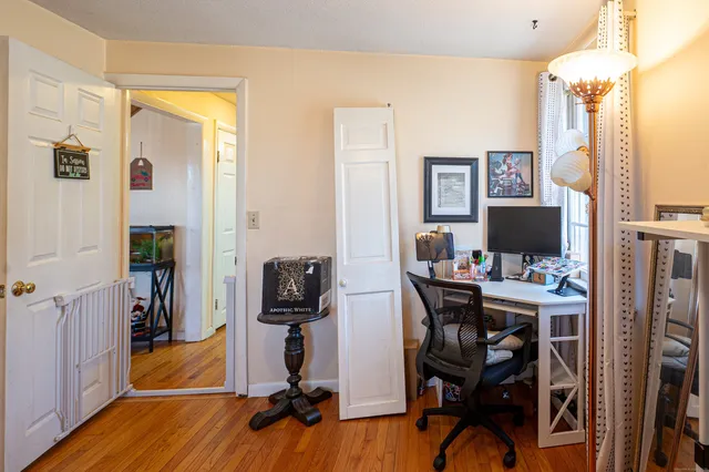 a view of a workspace with furniture and a bedroom