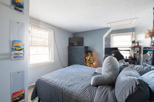 a bed room with a bed and a window