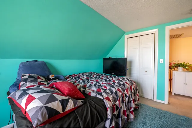 a bedroom with a bed and a television