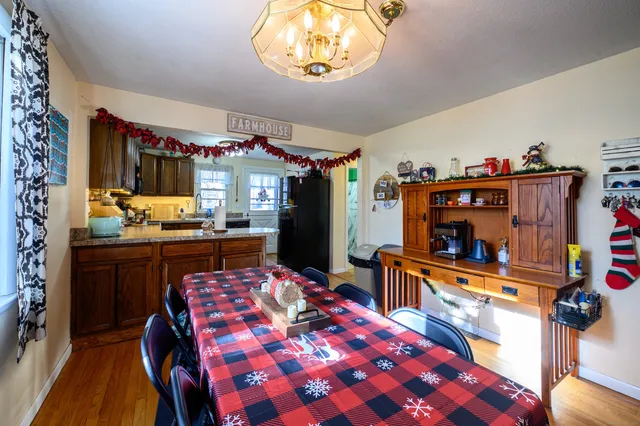 a room with stainless steel appliances kitchen island granite countertop a sink and cabinets
