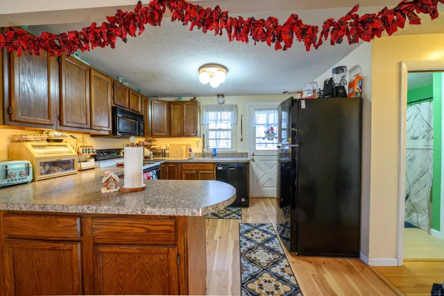 a kitchen with granite countertop lots of stainless steel appliances granite countertop a refrigerator and a sink