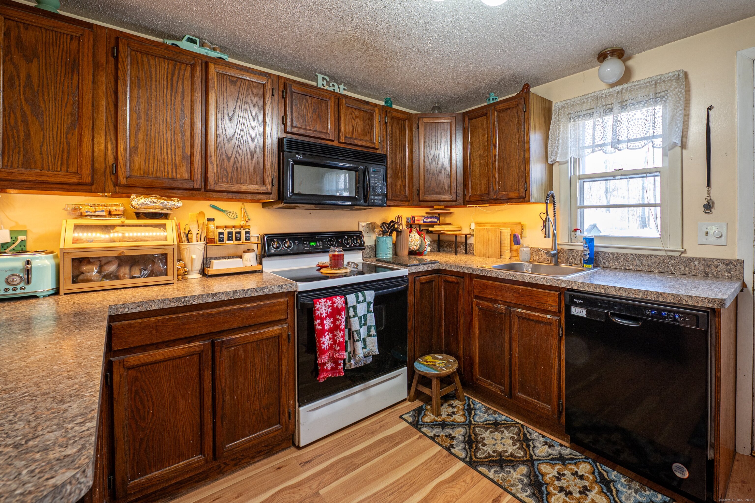 1940 Mt Vernon Road Southington, CT 06489 - Photo 8 of 24 a kitchen with wooden cabinets and a stove top oven