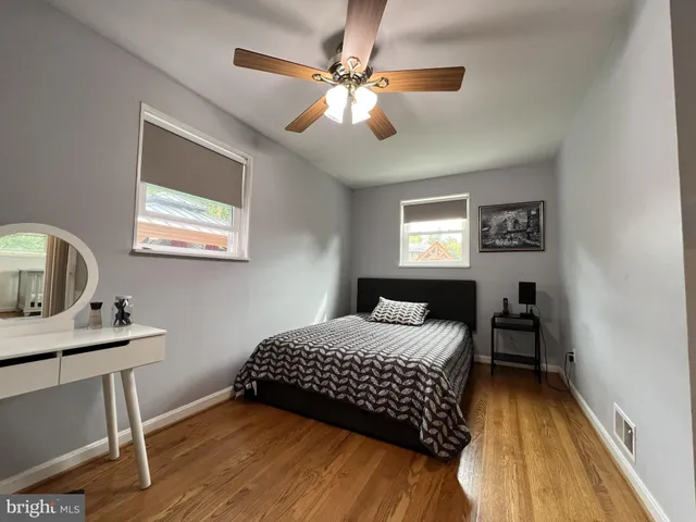 a bedroom with a bed and a desk