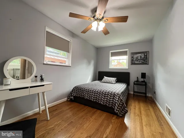 a bedroom with a bed window and a table