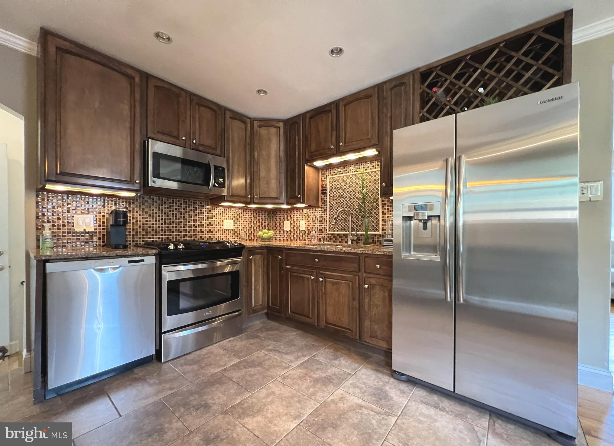 1001 Gabel Street Silver Spring, MD 20901 - Photo 28 of 46 a kitchen with stainless steel appliances granite countertop a refrigerator a stove a sink and a microwave