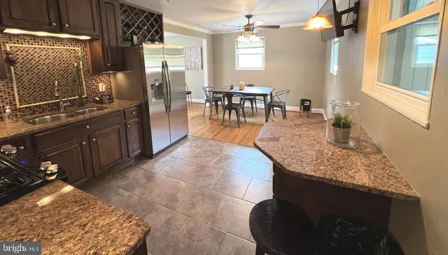 a kitchen with stainless steel appliances granite countertop sink stove and granite counter top