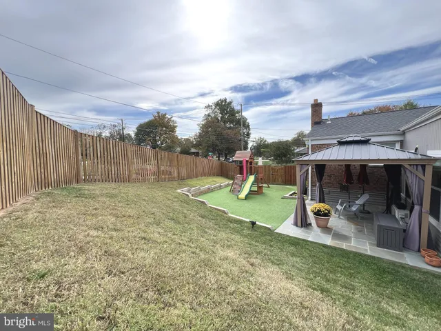 a view of a backyard with a slide and a slide