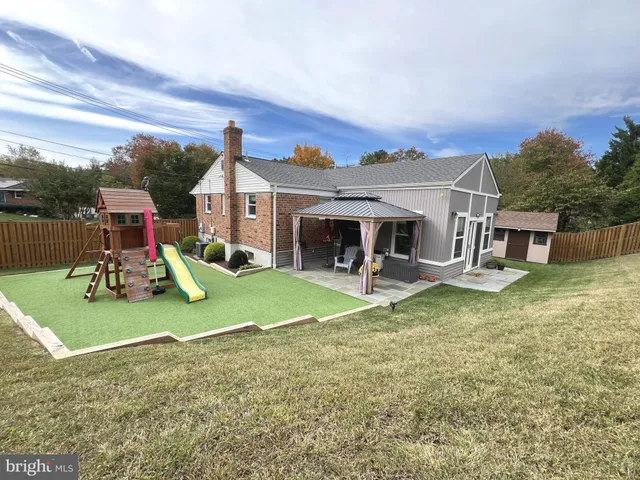 a view of a house with a porch and a yard