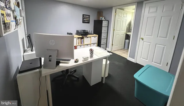 a room with chairs cabinets and wooden floor