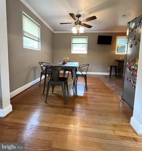 a view of a dining room with furniture and window
