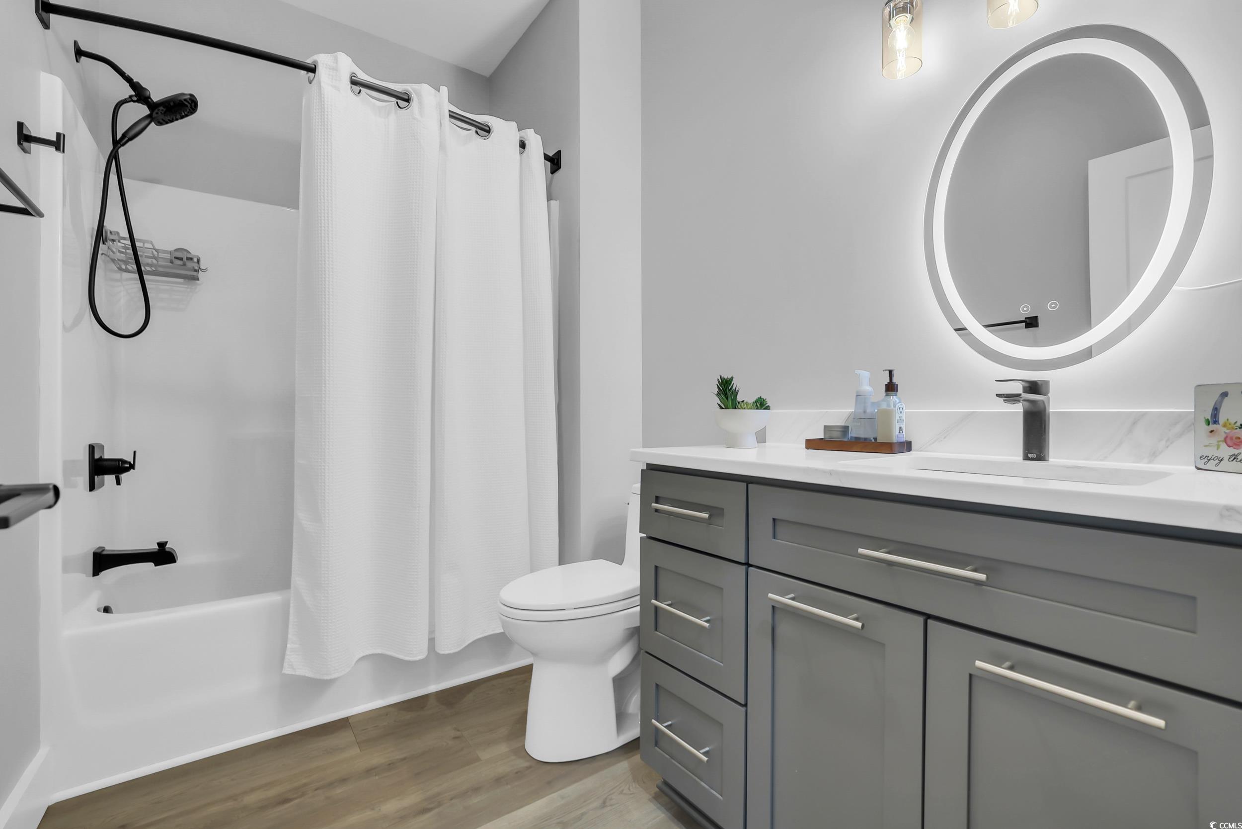 7356 Johnson Shortcut Road Conway, SC 29527 - Photo 17 of 40 Bathroom with vanity, wood finished floors, and shower / tub combo