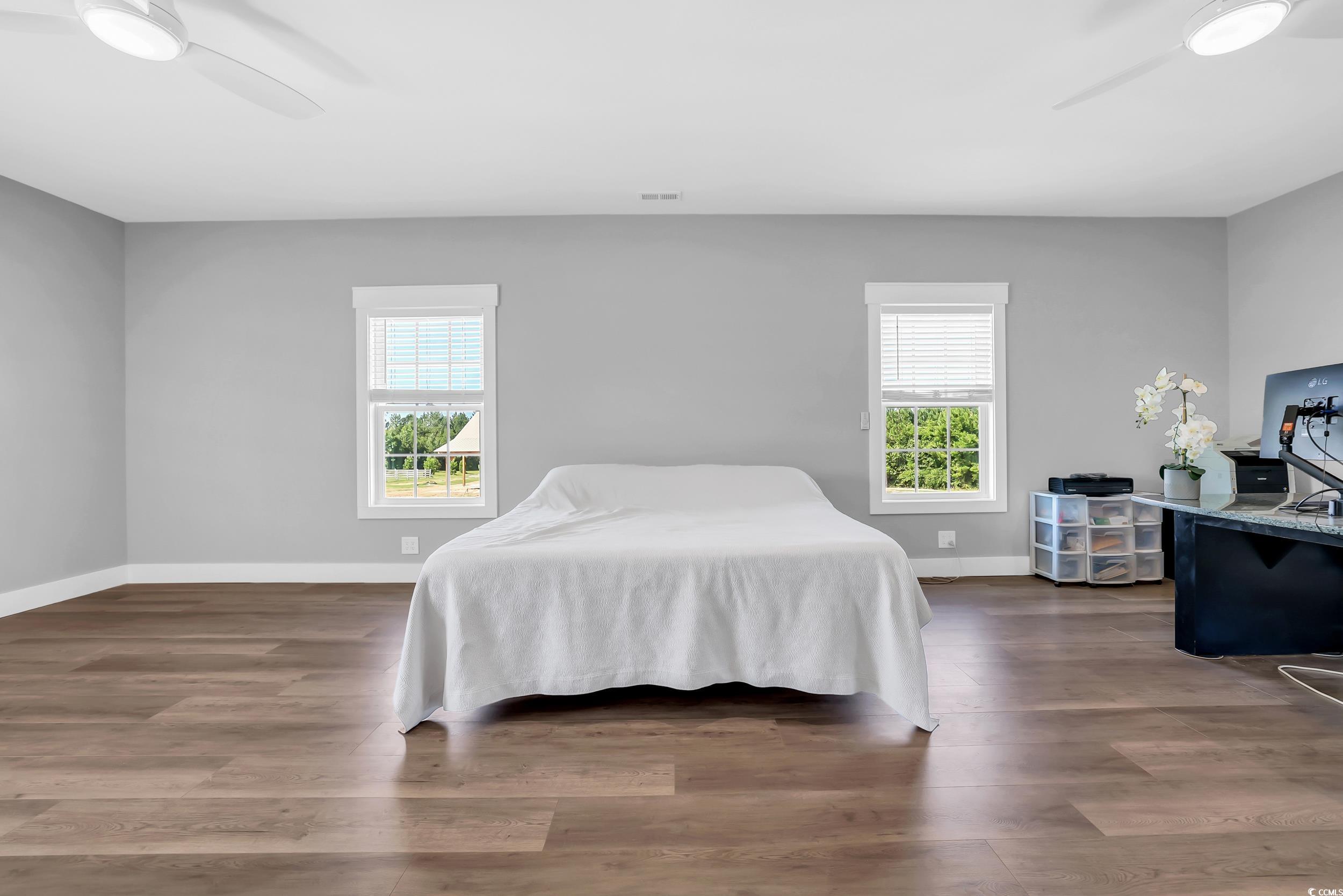 7356 Johnson Shortcut Road Conway, SC 29527 - Photo 24 of 40 Bedroom featuring multiple windows, wood finished floors, and a ceiling fan
