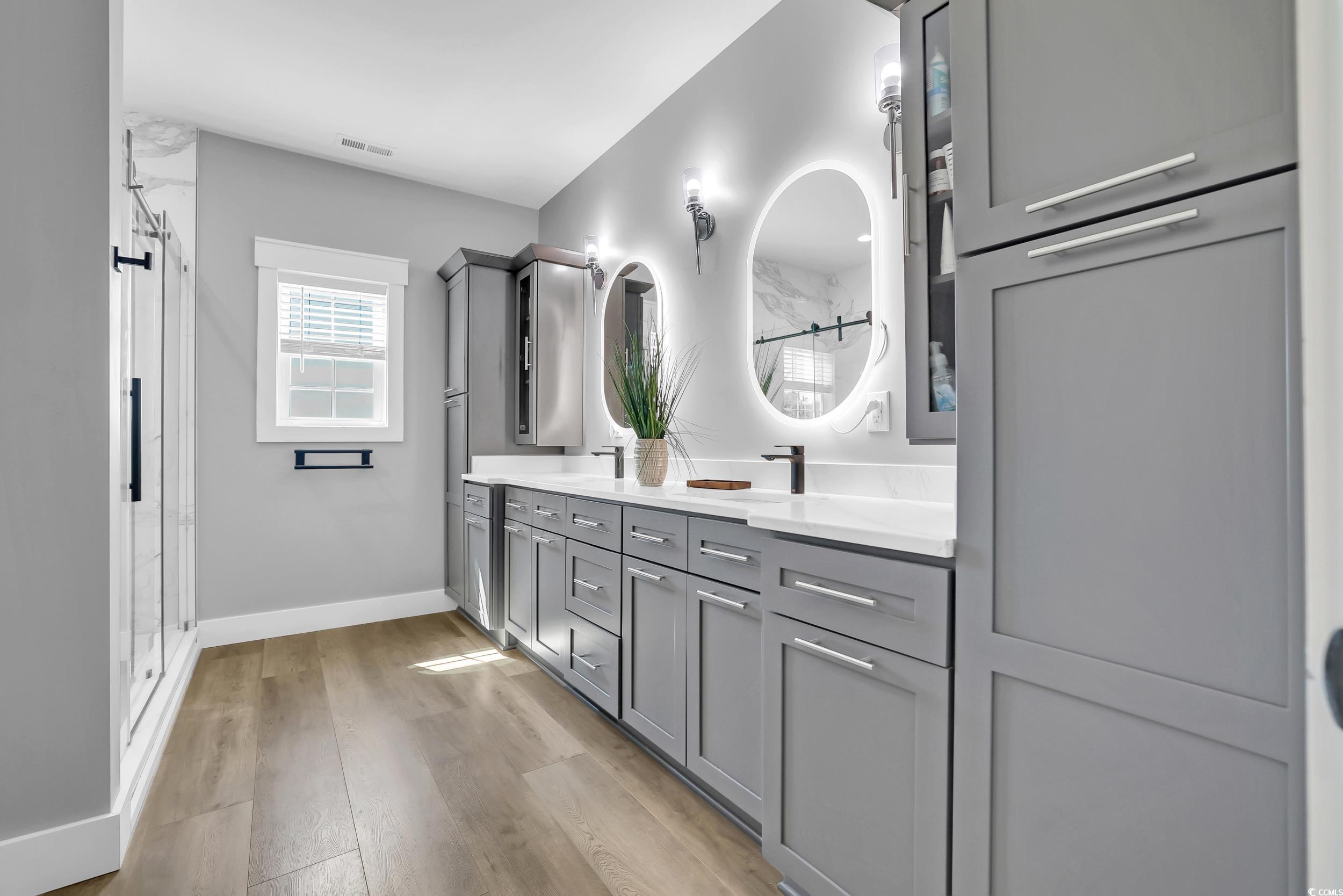 7356 Johnson Shortcut Road Conway, SC 29527 - Photo 26 of 40 Full bathroom with double vanity, a stall shower, and wood finished floors