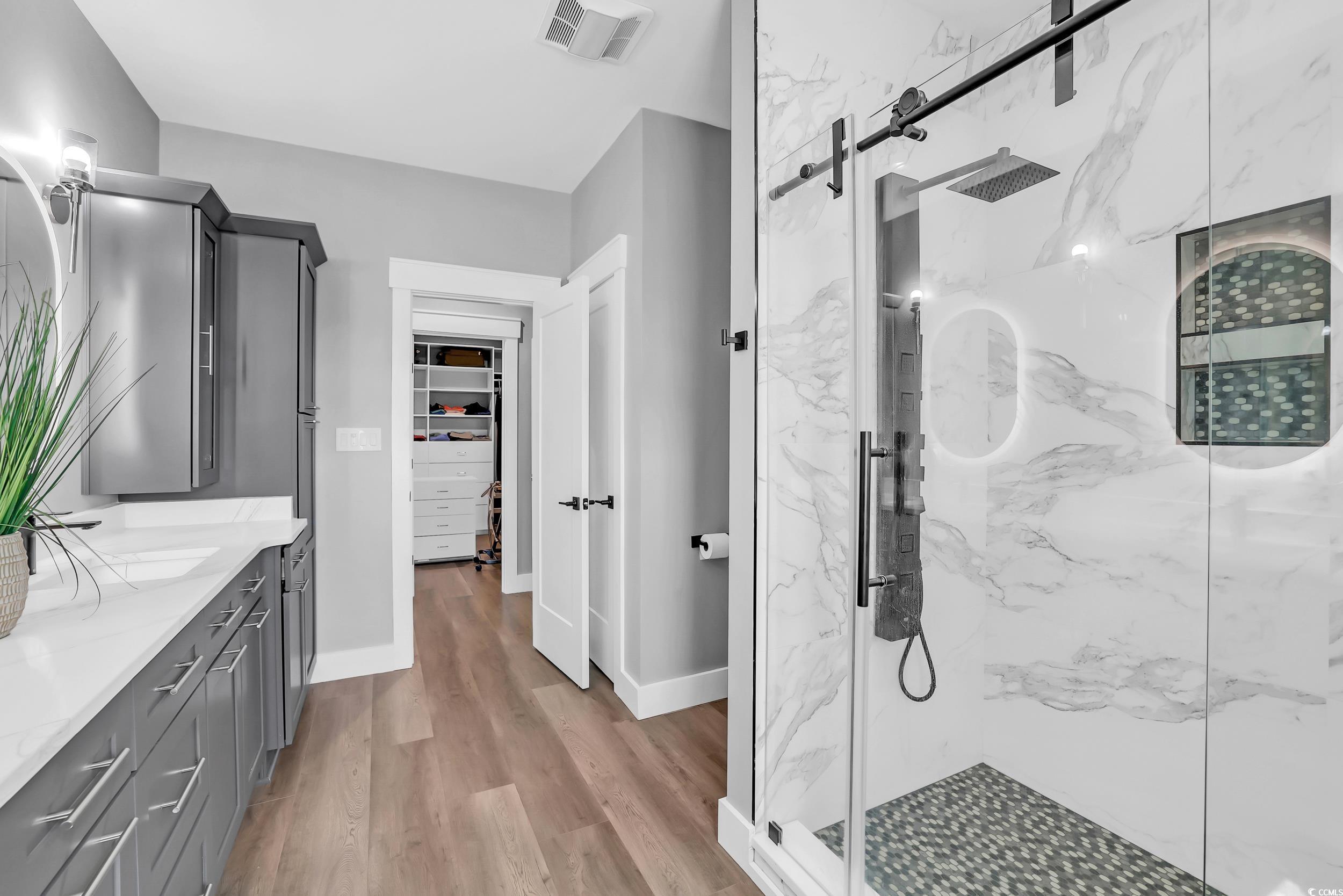 7356 Johnson Shortcut Road Conway, SC 29527 - Photo 28 of 40 Full bath with a marble finish shower, vanity, wood finished floors, and a walk in closet