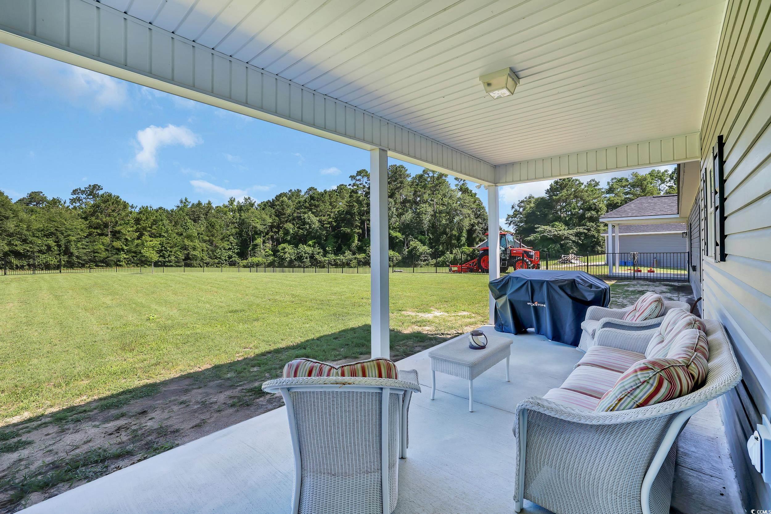 7356 Johnson Shortcut Road Conway, SC 29527 - Photo 32 of 40 Fenced backyard with a patio area, a grill, a playground, and an outdoor living space