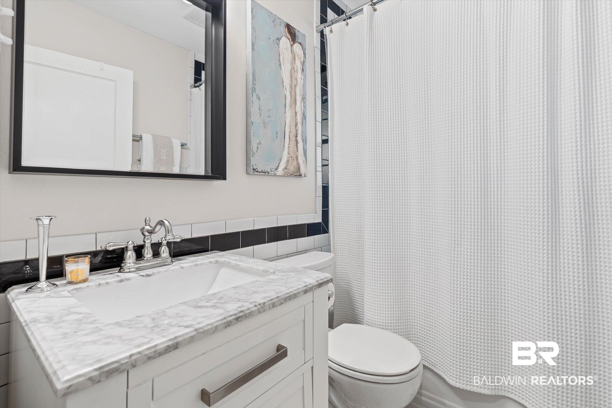 4310 The Cedars Avenue Mobile, AL 36608 - Photo 20 of 32 Full bathroom with tile walls, vanity, and a wainscoted wall