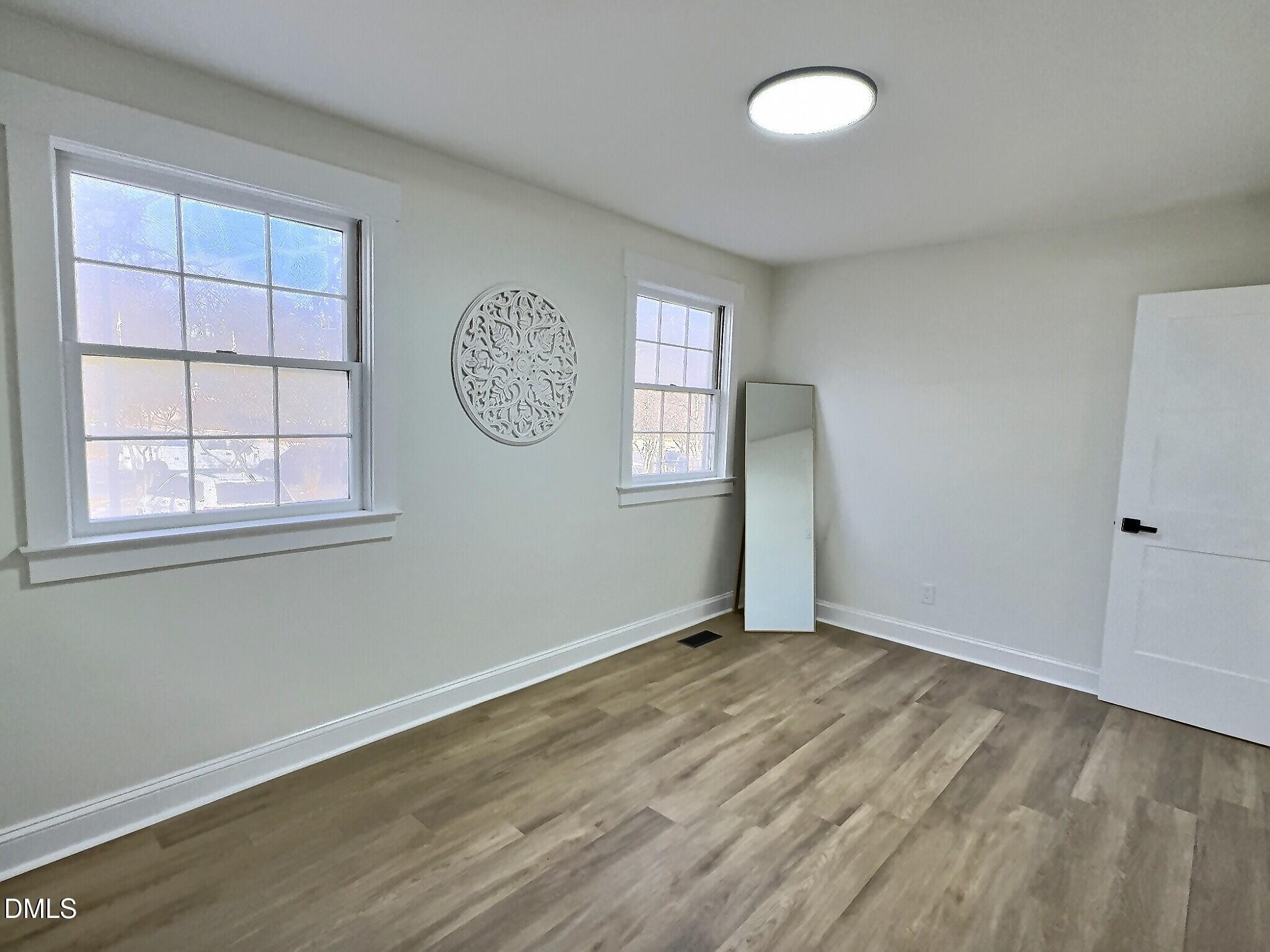 707 Wade Avenue Raleigh, NC 27605 - Photo 10 of 14 an empty room with windows and closet