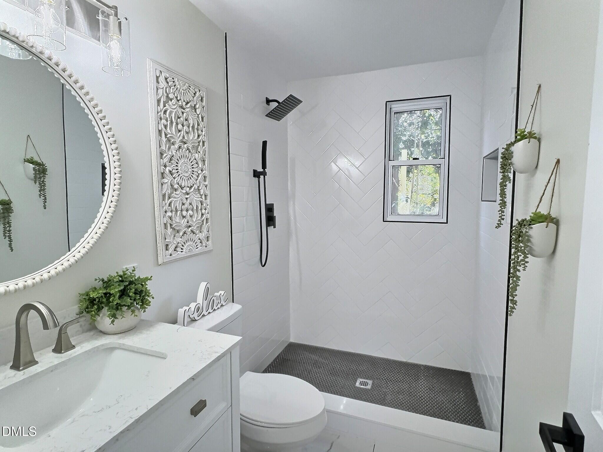 707 Wade Avenue Raleigh, NC 27605 - Photo 7 of 14 a bathroom with a sink a toilet and shower
