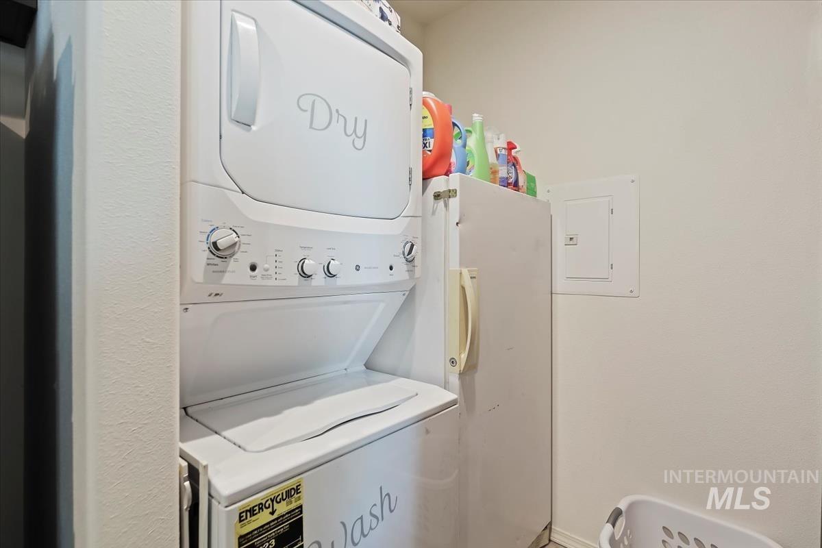 424 West Cherry Lane, Unit 94 Meridian, ID 83642 - Photo 11 of 31 Laundry room featuring electric panel and estacked washer and dryer
