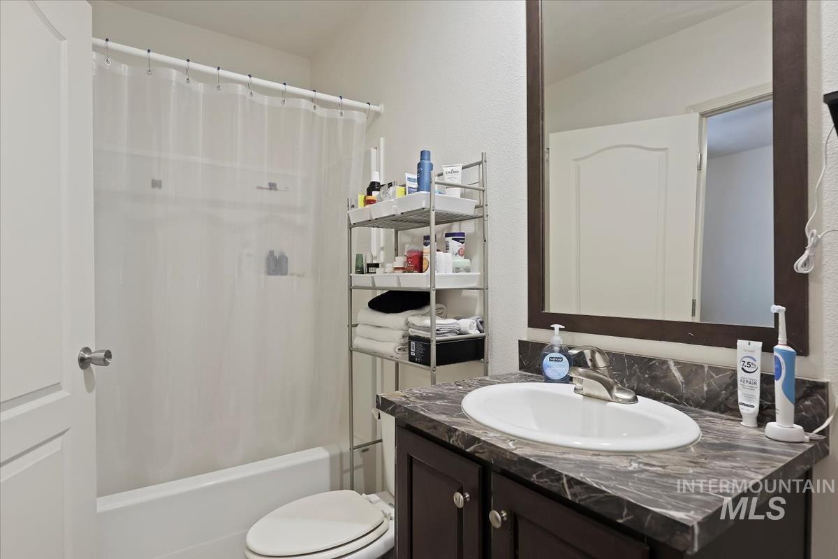 424 West Cherry Lane, Unit 94 Meridian, ID 83642 - Photo 20 of 31 Bathroom featuring vanity and shower / bath combination with curtain