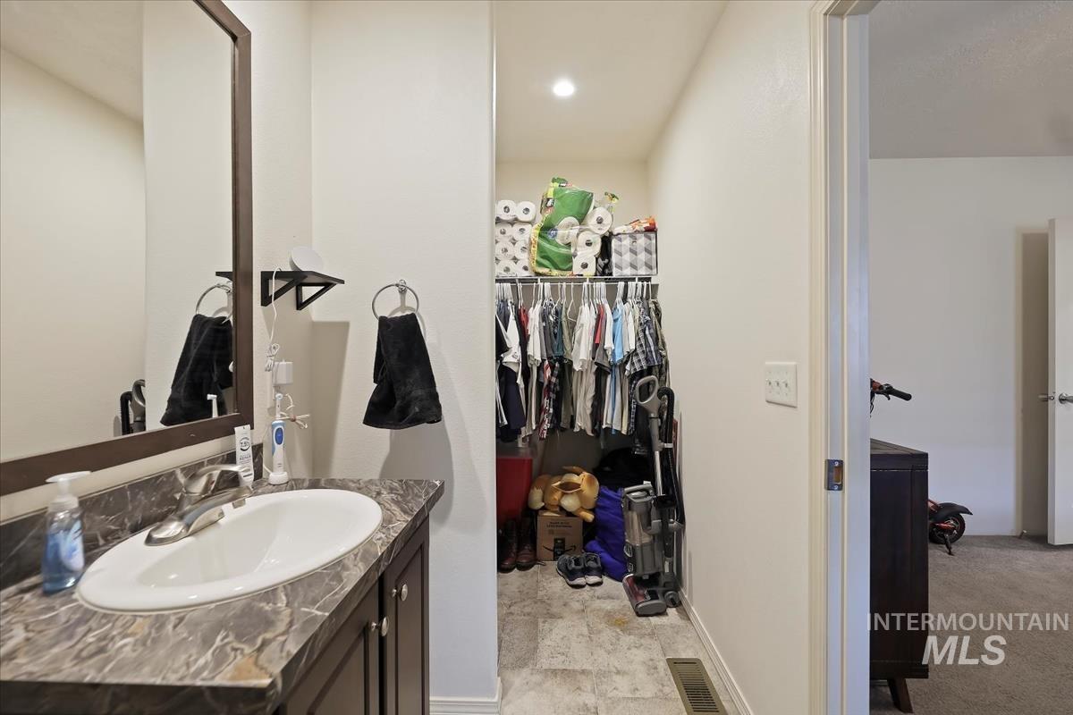 424 West Cherry Lane, Unit 94 Meridian, ID 83642 - Photo 22 of 31 Bathroom with vanity and a walk in closet