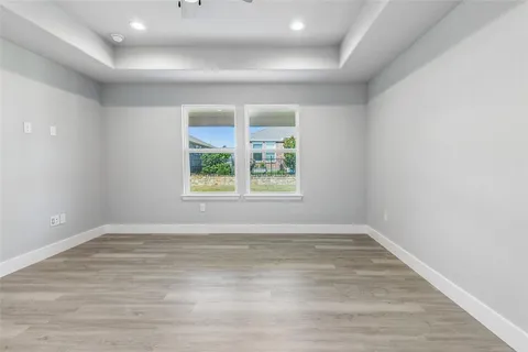 wooden floor in an empty room with a bathroom