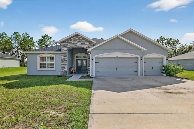 a front view of a house with a yard and garage