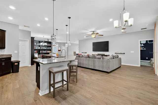a living room with kitchen island furniture and a flat screen tv