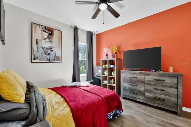 a bedroom with a bed and a flat screen tv